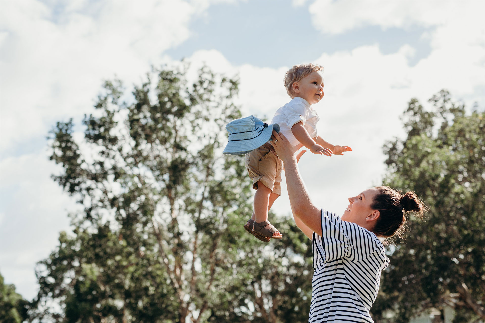 baby and mother in a park