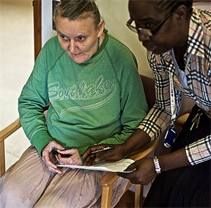 GP helping older person with a questionnaire