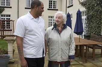 two people smiling and chatting