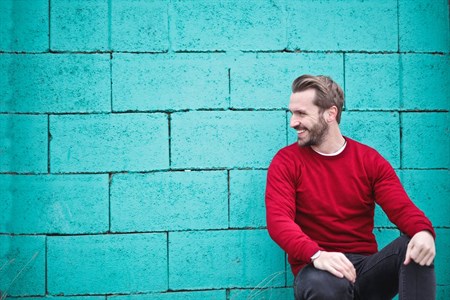 man sitting and smiling 