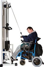 man in wheelchair using a weight machine