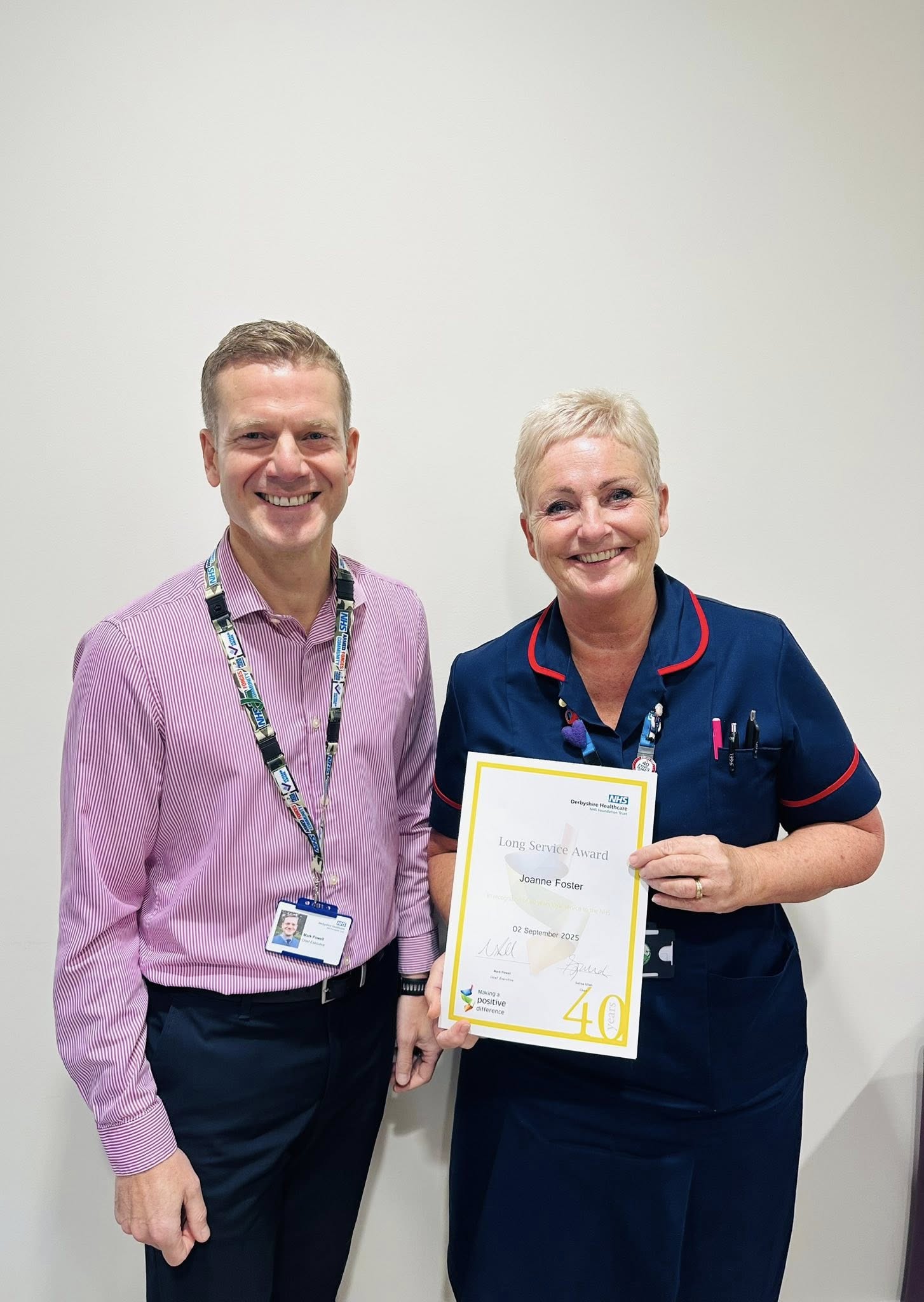 Mark Powell with Jo Foster presenting a certificate for 40 years NHS service