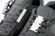 a pair of shoes with a magnet on the laces